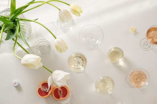Glasses of Fria Frio Vinho Verde White and Rosé on a table with fresh white tulips